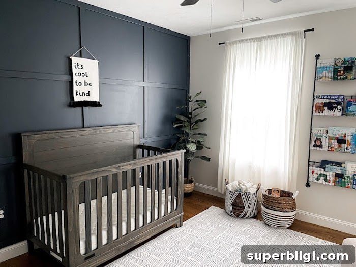 20 Nursery Paint Colors and Accent Wall Ideas for Baby Rooms 10 Boy's nursery with Hale Navy accent wall and wood crib.