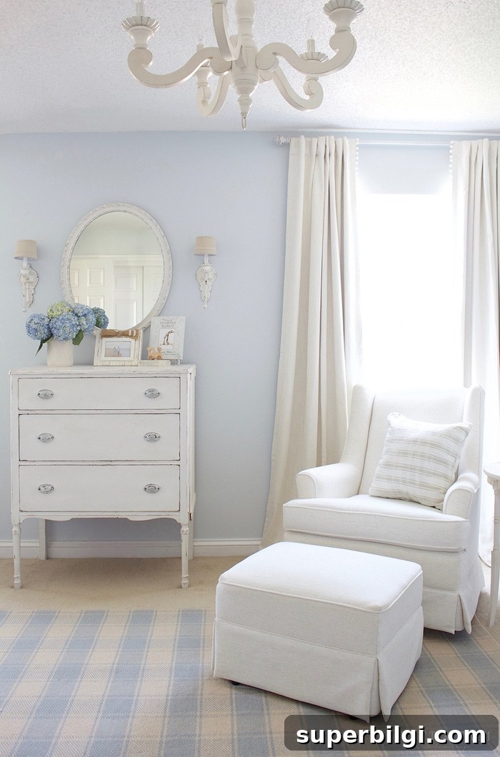 20 Nursery Paint Colors and Accent Wall Ideas for Baby Rooms 12 Traditional boy's nursery with blue walls and white glider and ottoman.