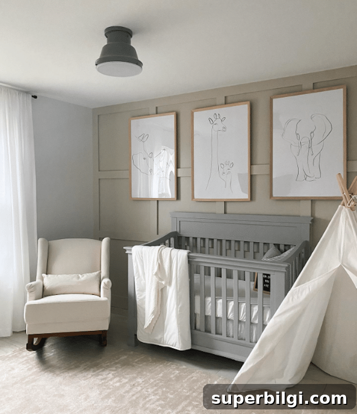 20 Nursery Paint Colors and Accent Wall Ideas for Baby Rooms 15 Animal art hanging over a gray crib in a nursery with Revere Pewter walls and a white glider.