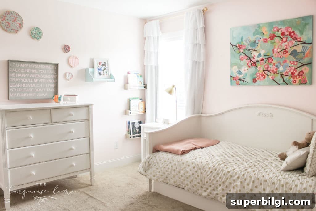 20 Nursery Paint Colors and Accent Wall Ideas for Baby Rooms 6 gold, pink and turquoise girls bedroom decor with hoop art and white daybed with white dresser.