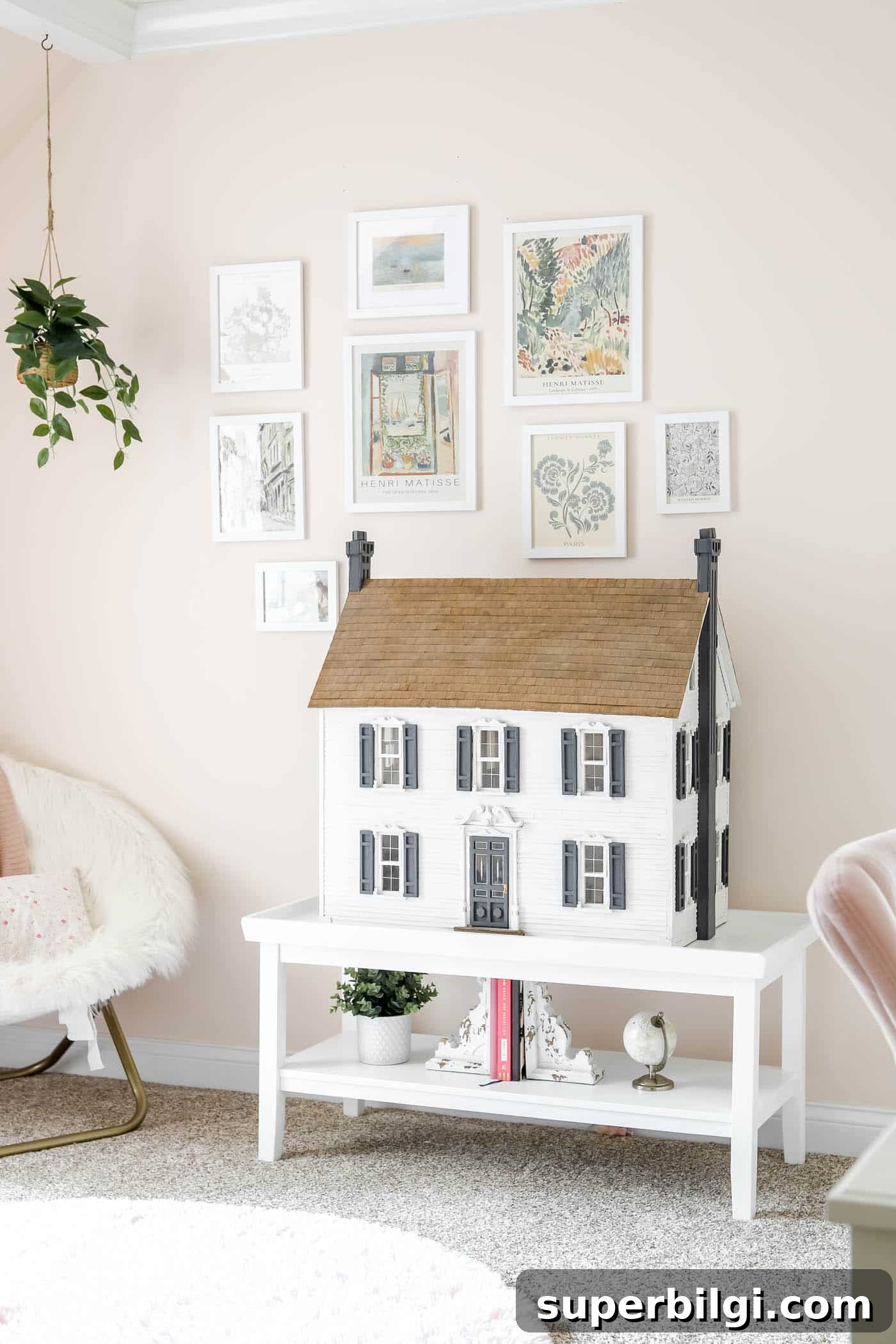 Teen Girl Bedroom Ideas: 10+ Stylish Tips and Tricks 9 gallery wall on a pink wall with a dollhouse on a coffee table.