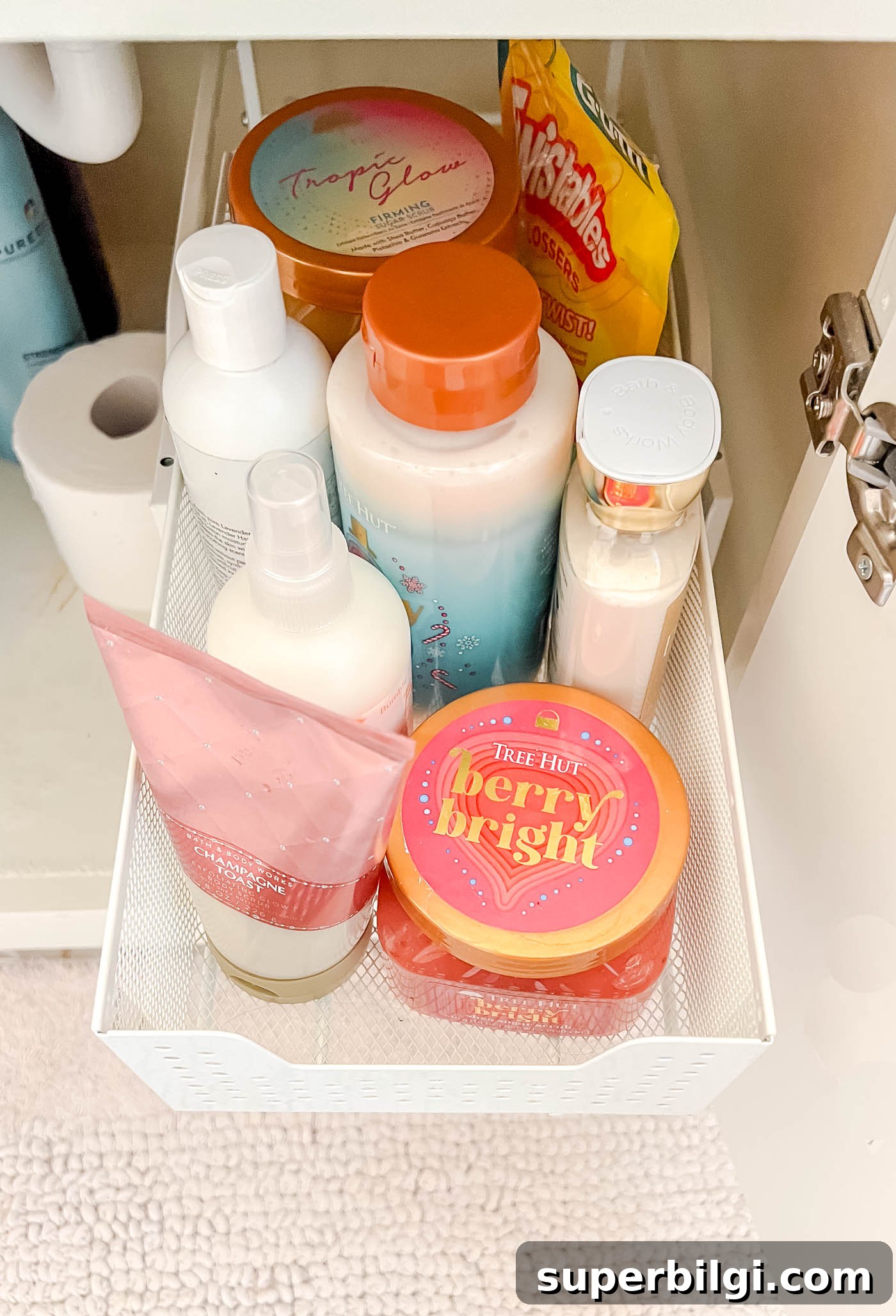 Under-Sink Storage Ideas for Bathroom Organization 4 lotions and other beauty products in bottles in a sliding drawer organizer