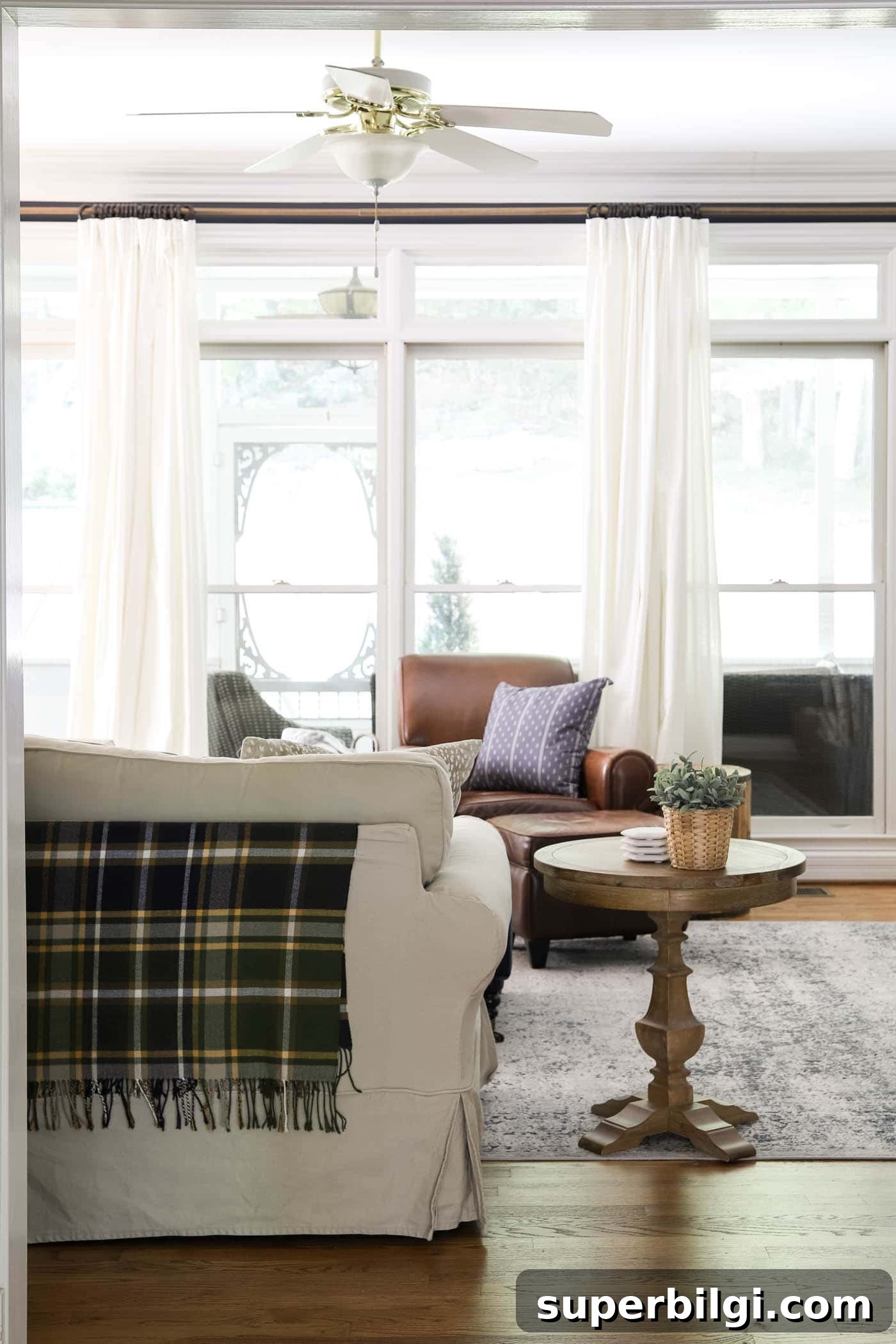 10 Cozy Fall Throw Pillow Ideas to Refresh Your Autumn Decor 3 Plaid throw blanket on back of the sofa for fall decor