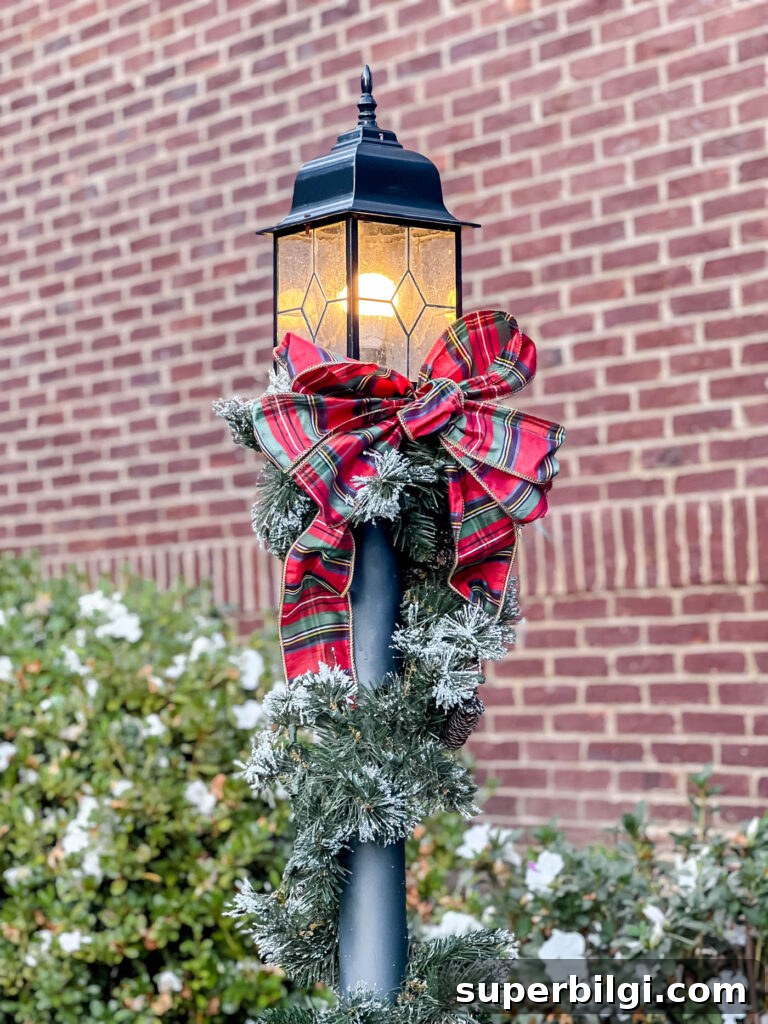 Outdoor Holiday Decor Deals: Lights, Wreaths and Lawn Displays 2 Lamppost with christmas garland and red plaid ribbon on it.