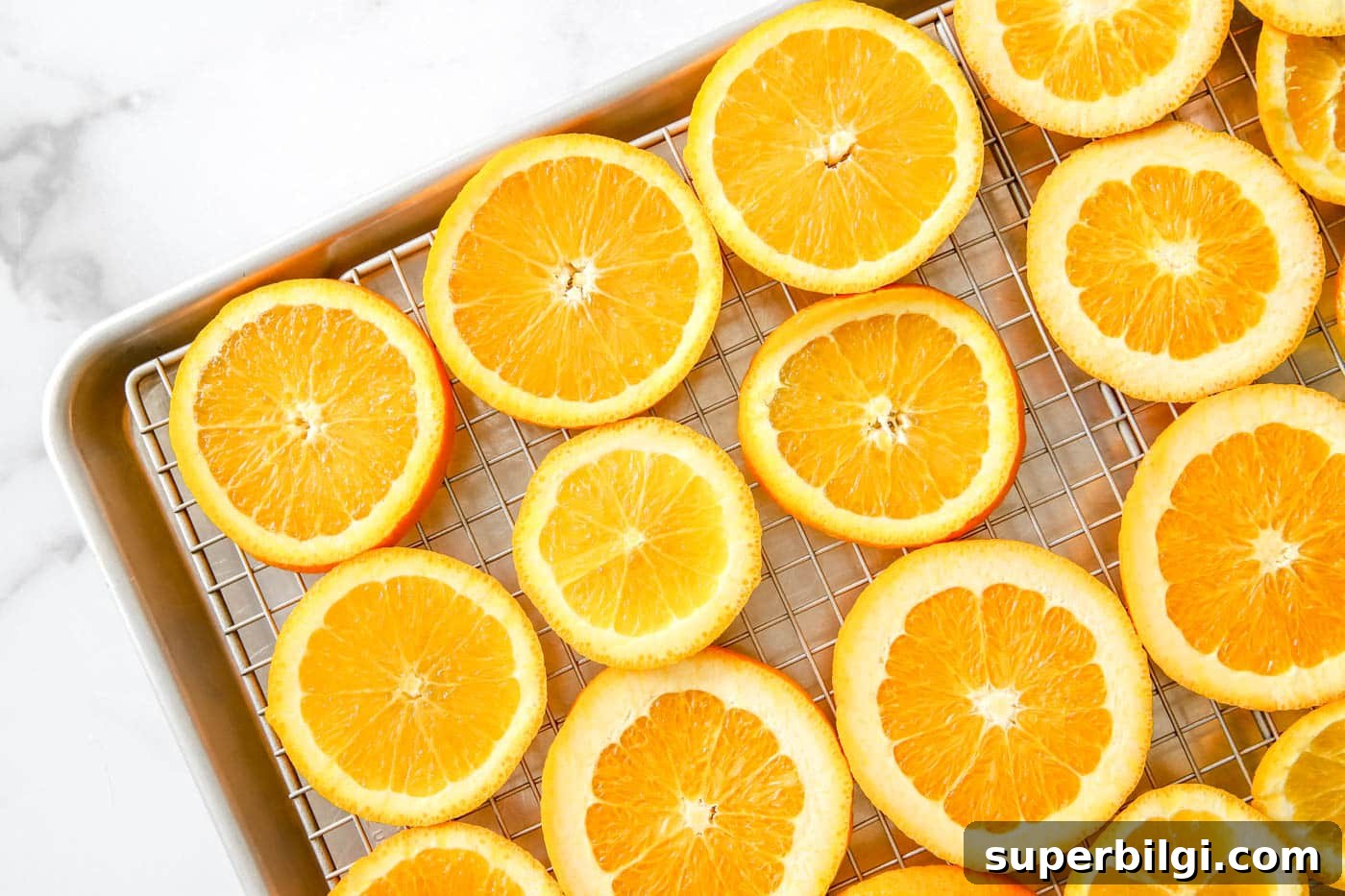 How to Dry Orange Slices for Crafts and Decorations 6 arrange oranges on a baking sheet.