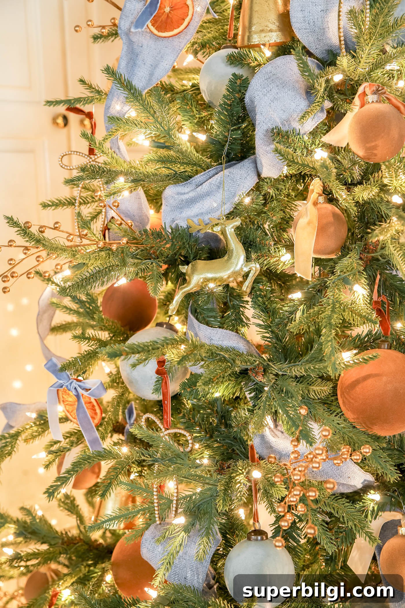 Orange, Blue and Brown Christmas Decor Ideas 21 blue ribbon on a pre=lit christmas tree