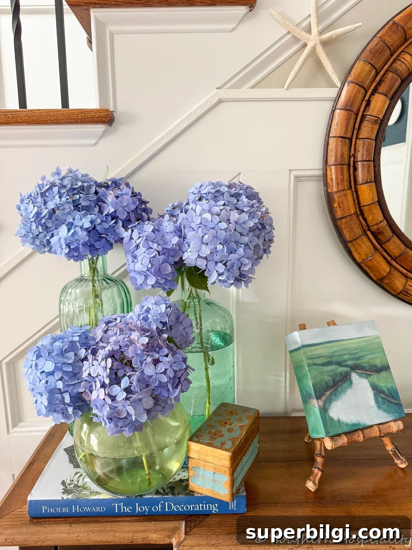 Summer Living Room: New Beige, Layering Tips and Decor 6 beautiful blue hydrangeas inside in vases on a table.