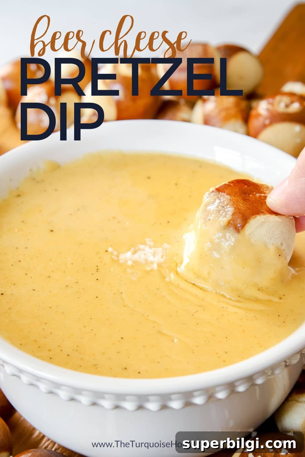 Creamy Beer Cheese Dip Recipe for Pretzels 2 beer cheese dip with a hand dipping a pretzel in it.