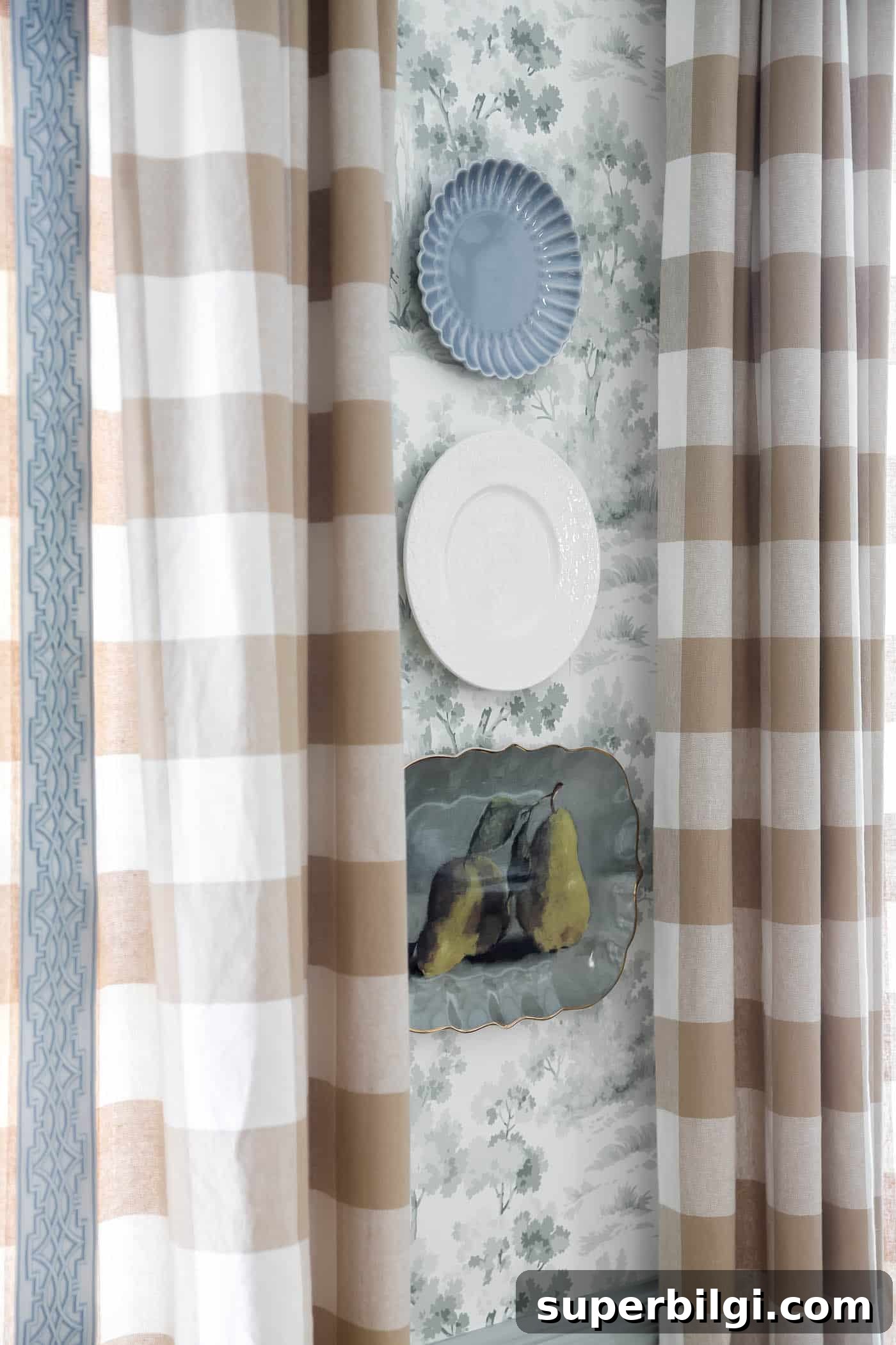 How to Hang Decorative Plates on a Wall Safely 4 blue, green and white plates on a wall with toile wallpaper.