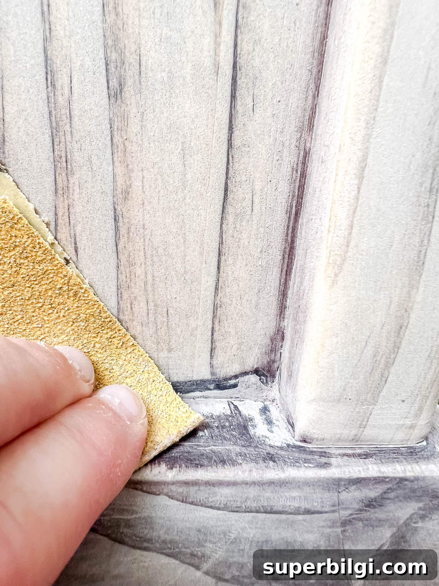sanding the corners for refinishing wood furniture.