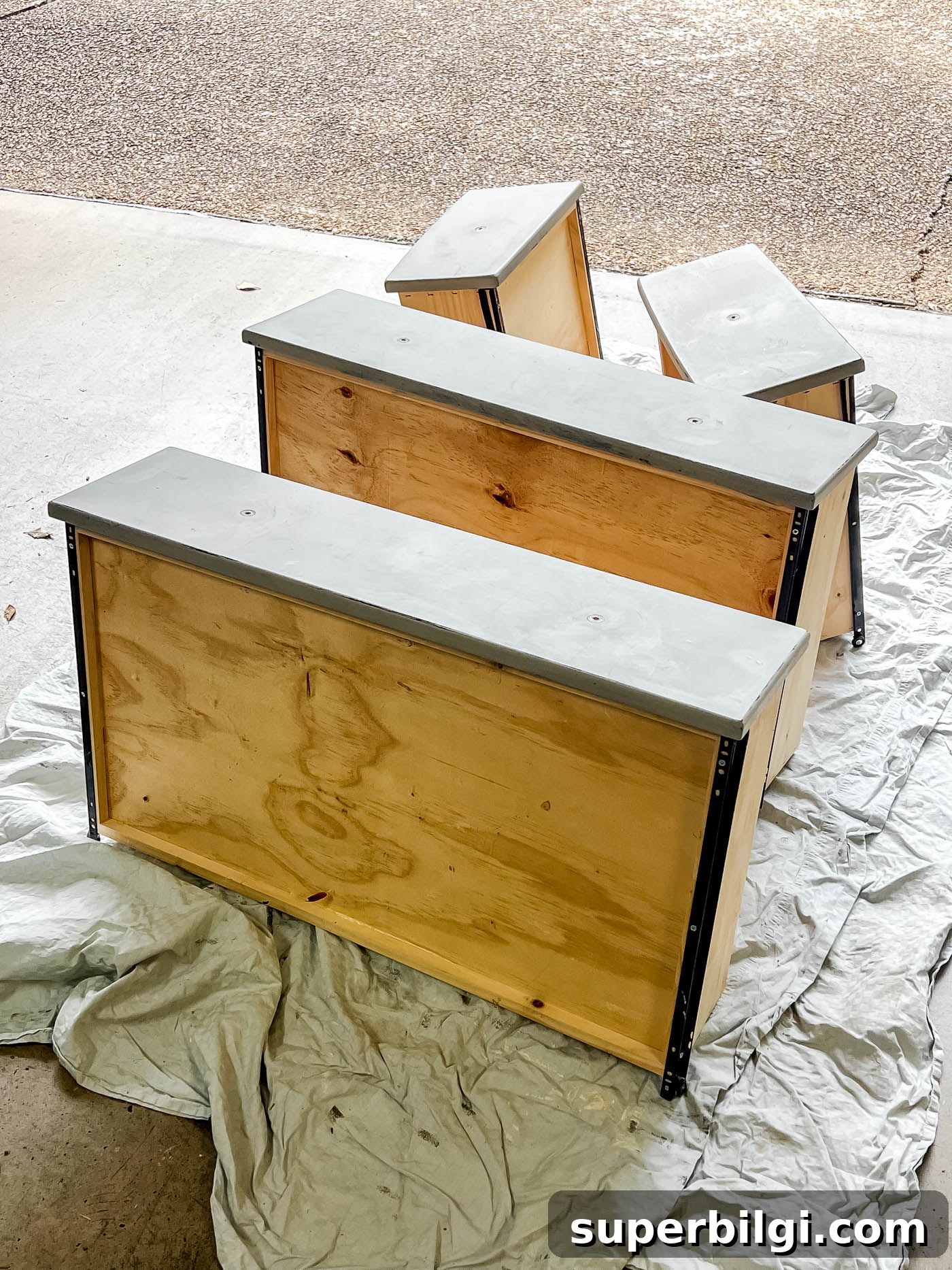 Drawers removed from dresser in the garage floor.