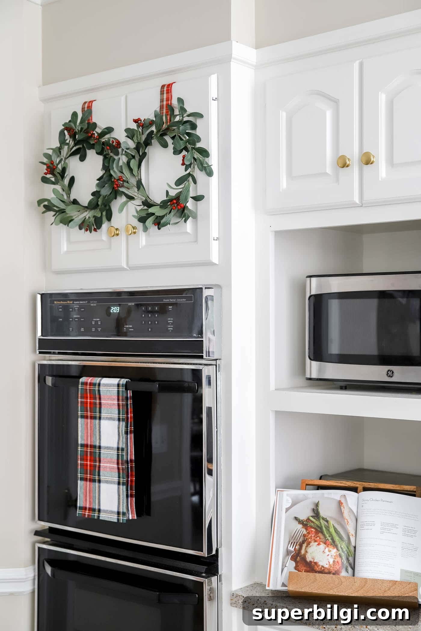 Christmas Decor Trends to Expect in 2025 6 Christmas kitchen with mini wreaths on cabinets