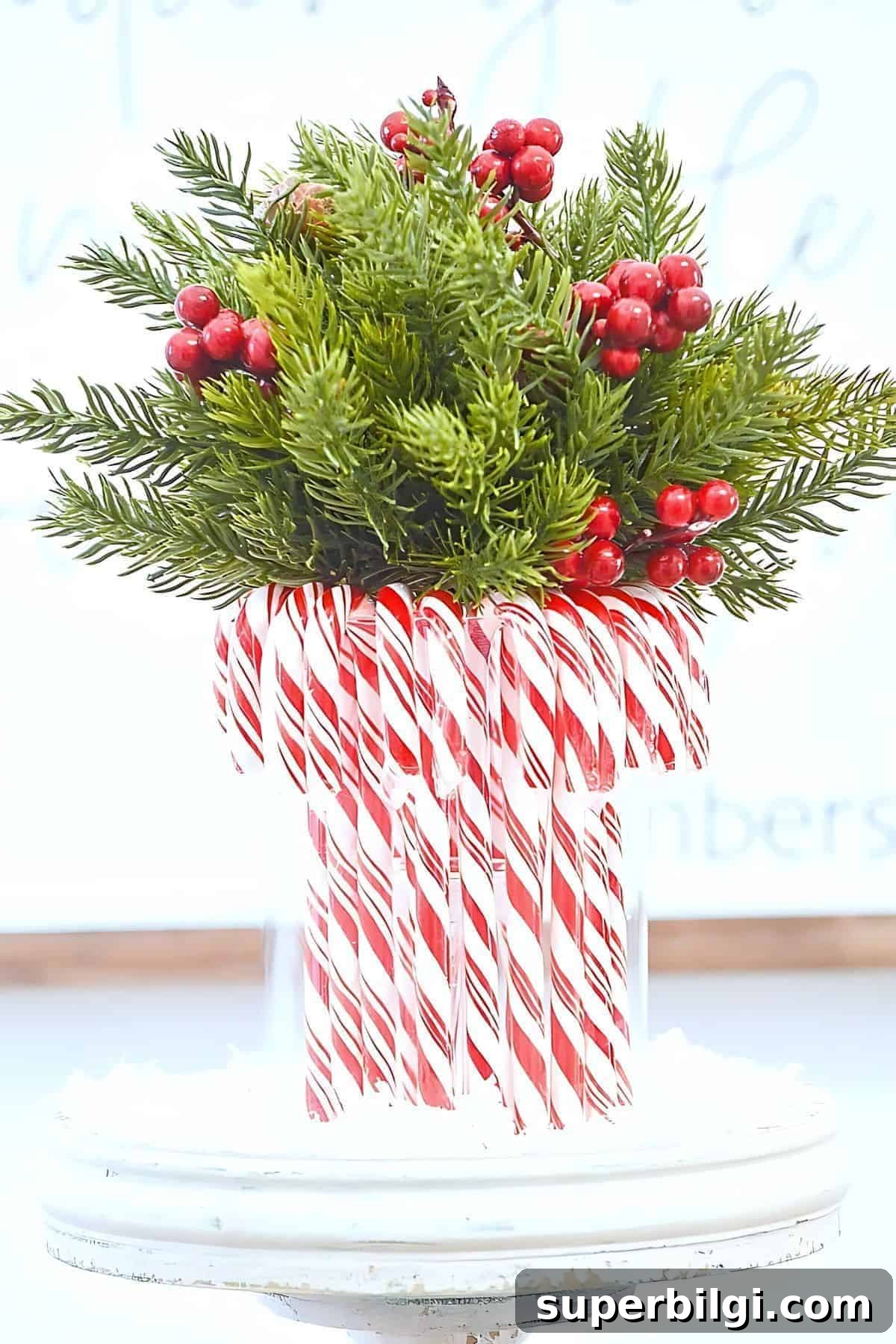 candy cane vase with greenery and berries