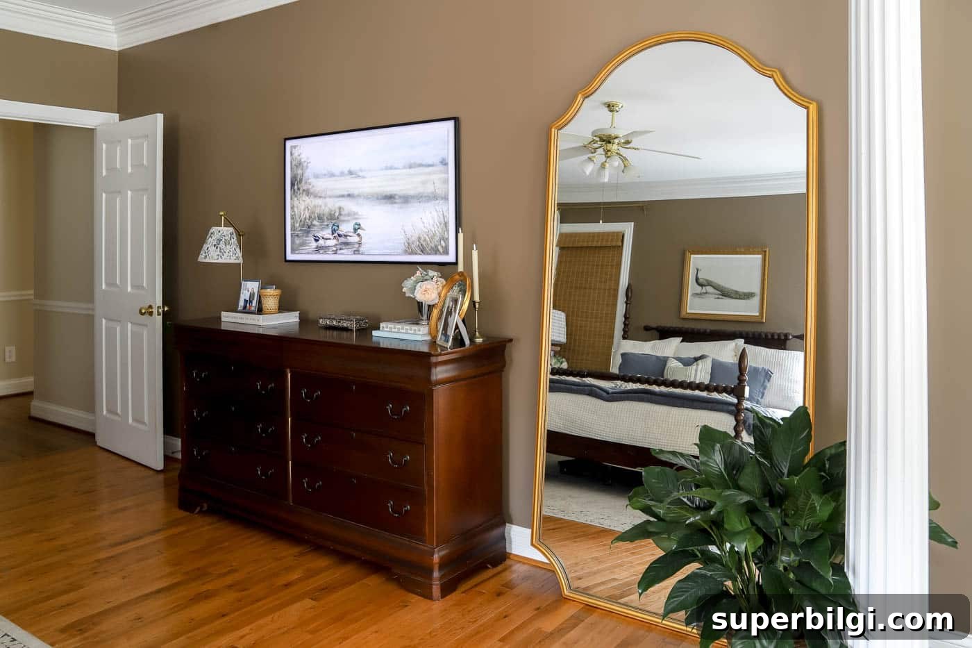 How an Oversized Floor Mirror Revitalized Our Bedroom Corner 6 how to style a leaning mirror between a dresser and a column.