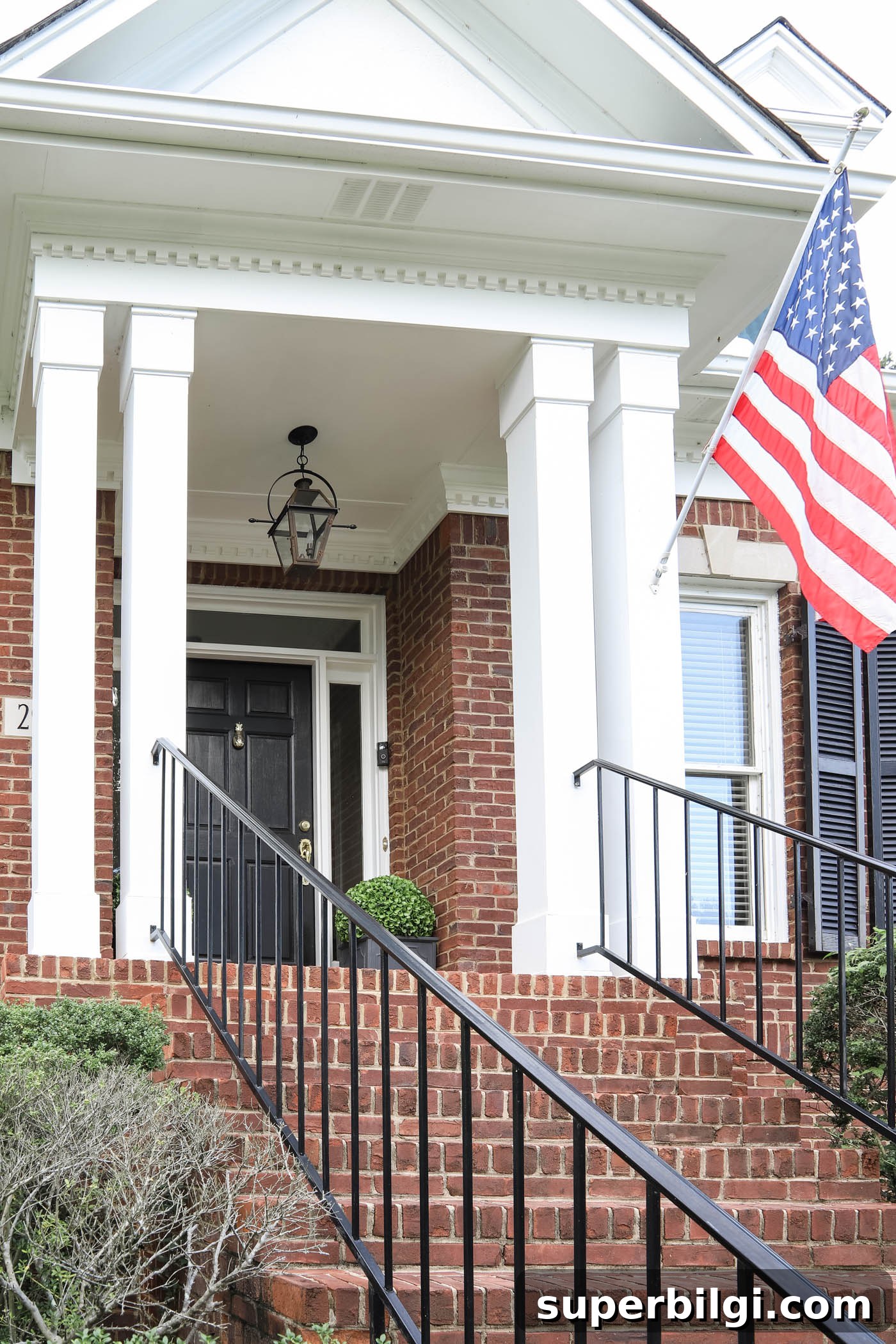Summer Home Decor: Fresh Flowers and DIY Lampshades 2 American flag on the front porch of a brick cape cod style home.