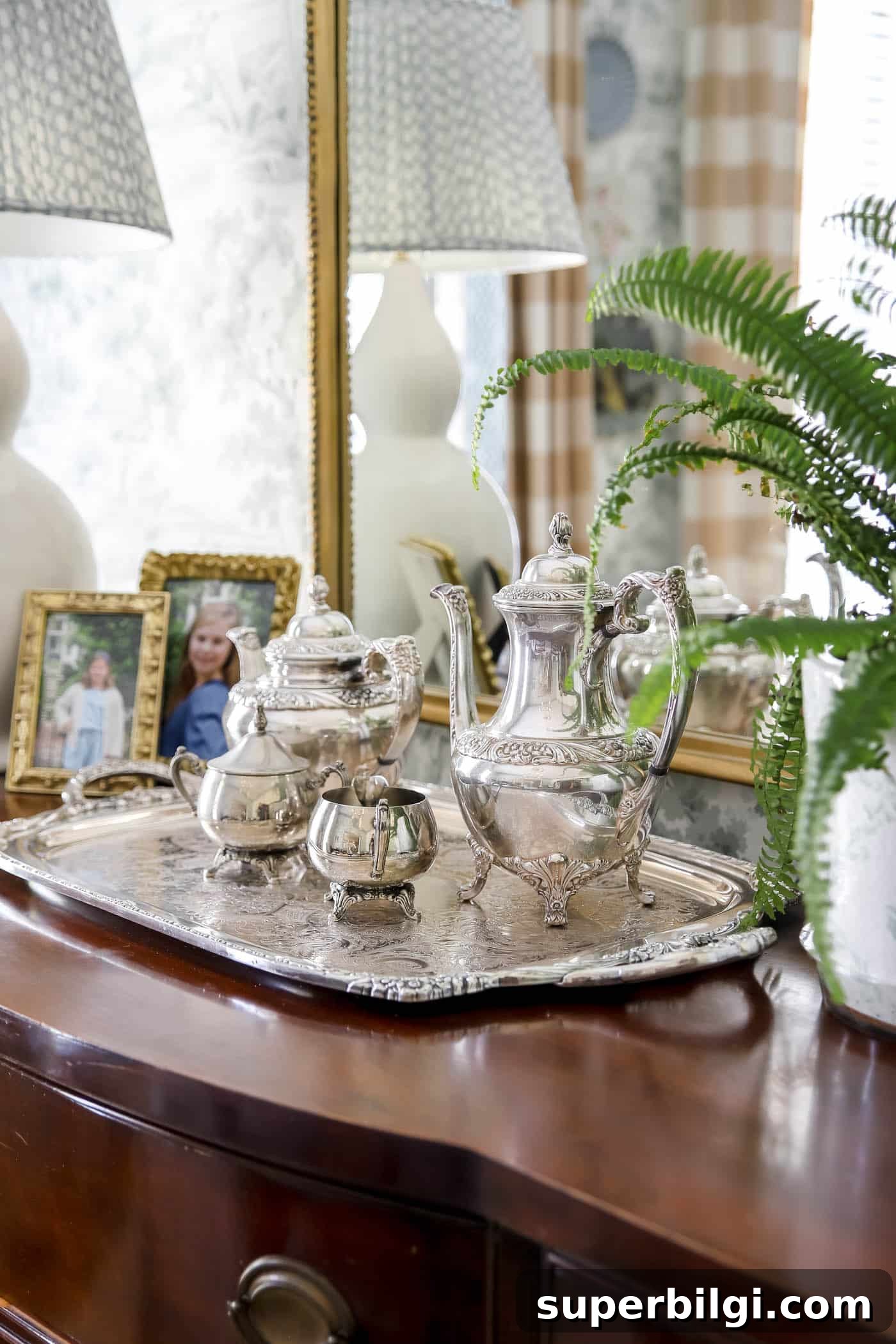 Use and Collect Inherited Antique Silver for Home Decor 9 silver tea tray, coffee pot, tea pot and cream and sugar pots on a wood dining buffet.