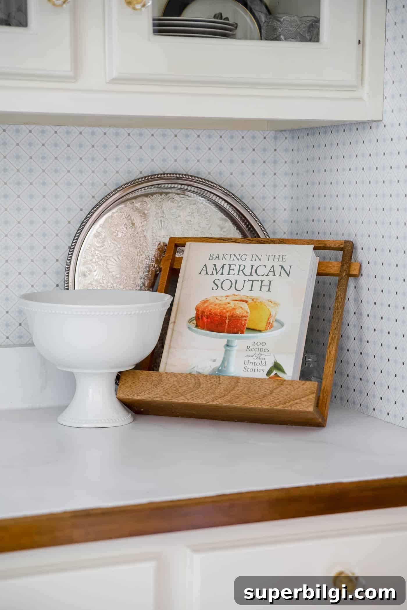 Use and Collect Inherited Antique Silver for Home Decor 5 galleried silver tray stands up against the wall in a blue and white butler's pantry