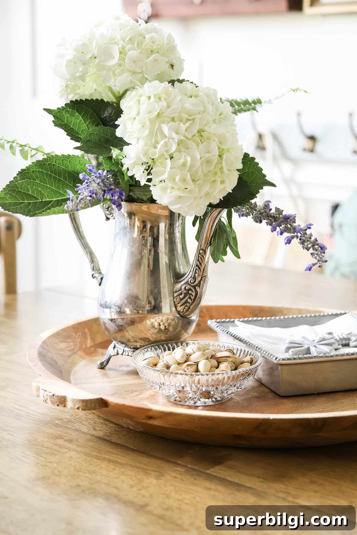 Use and Collect Inherited Antique Silver for Home Decor 7 decorating with antique silver coffee pot as a vase.